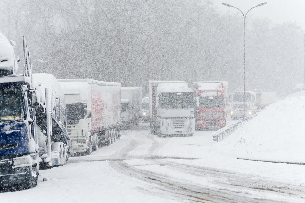 trucks parked on a highway due to bad weather