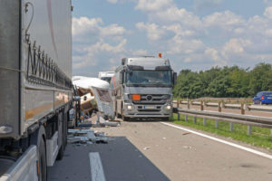 highway truck accident cause by tail gating trucks