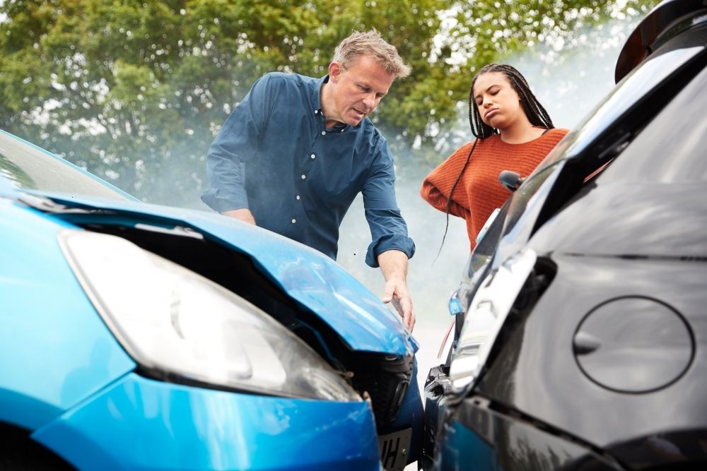 Two adults arguing after their cars collided