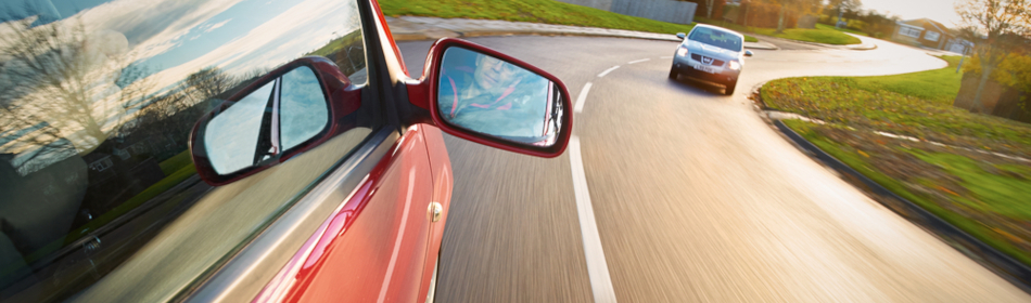 two cars getting ready to pass each other on the road