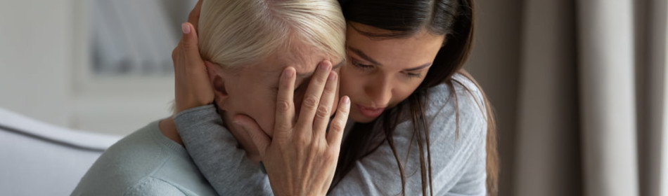 Grieving women comforting each other after a tragic loss
