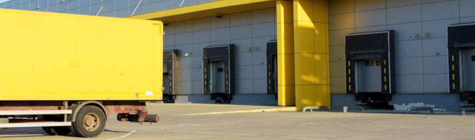 Truck trailer standing close to warehouse