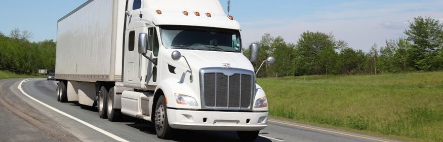 White truck drives down the road