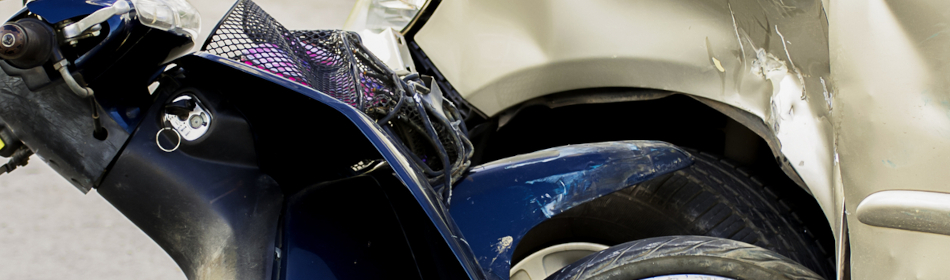 a motorcycle crashed into the side of a car.
