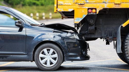 Car that has ridden under a large truck causing a collision